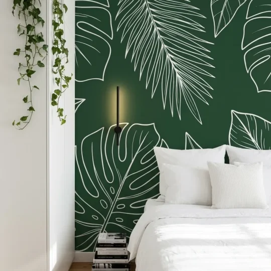 Modern Scandinavian bedroom with a large white tropical leaf line art mural on a dark forest green accent wall.