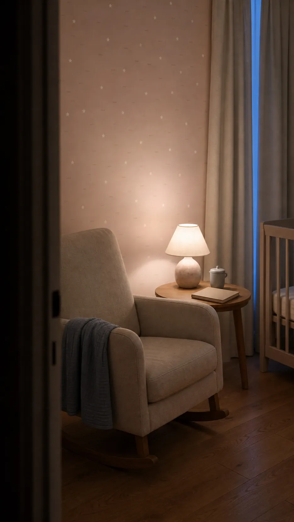 Very light pink wallpaper nursery viewed under a gentle night light during evening routine