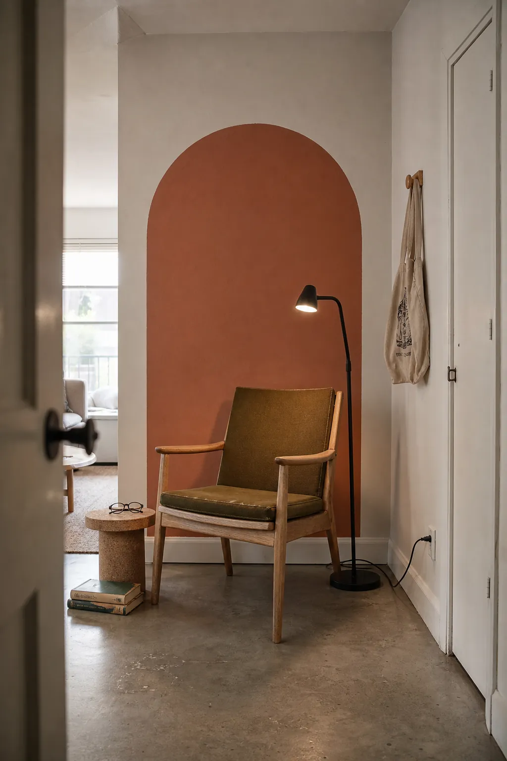 Terracotta painted arch mural framing a compact reading corner