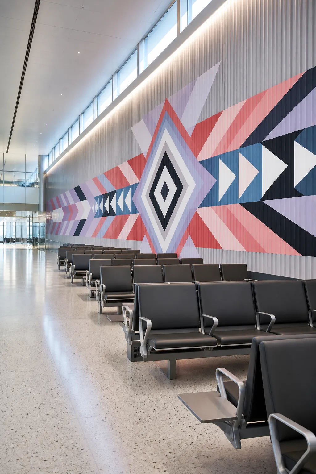 Waiting area energized by a mural of colorful angular geometric forms