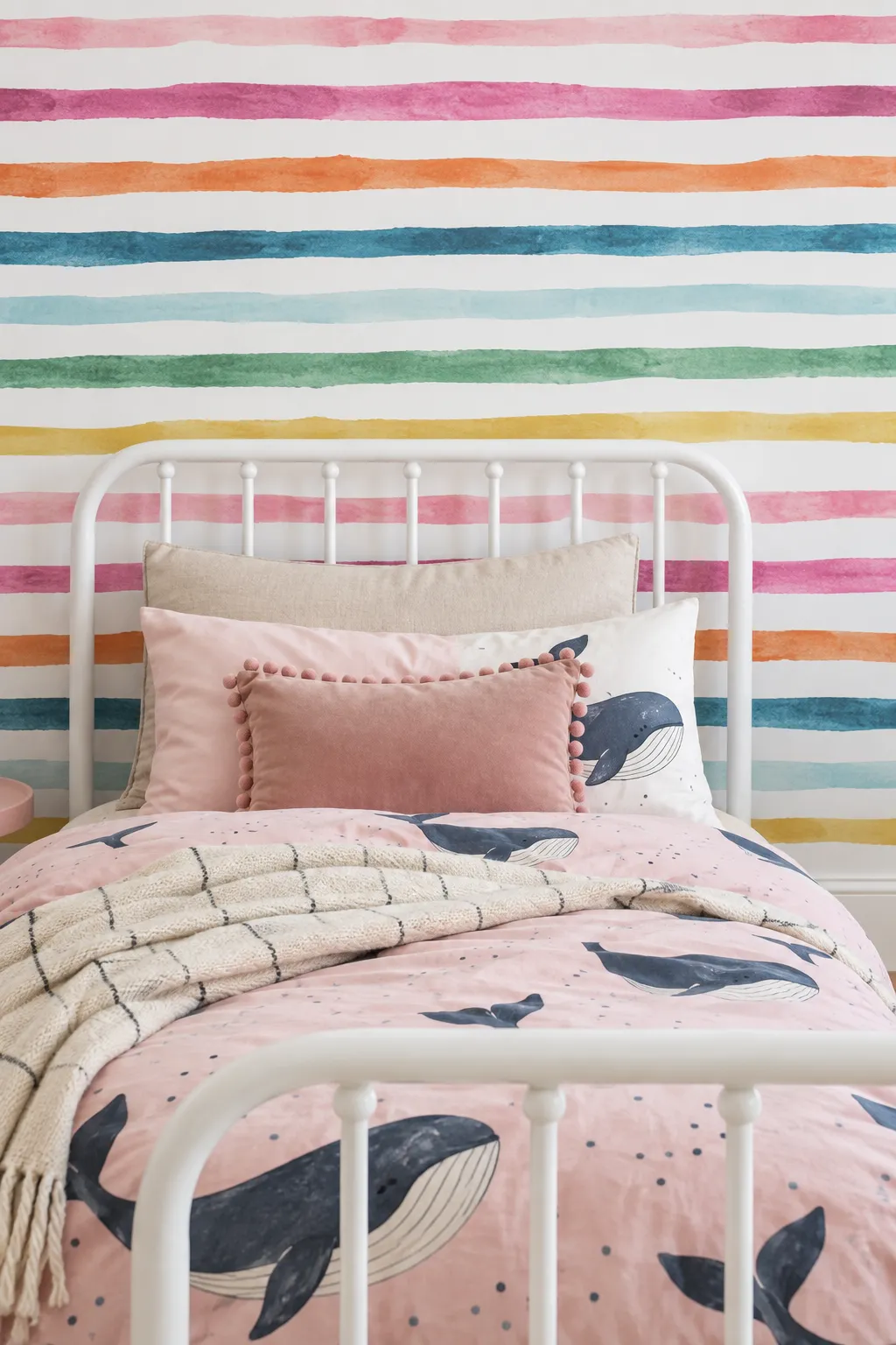 Rainbow watercolor lines on the wall behind a white bed